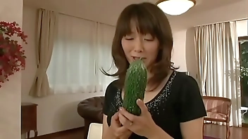 Japanese m. masturbating with a big cucumber